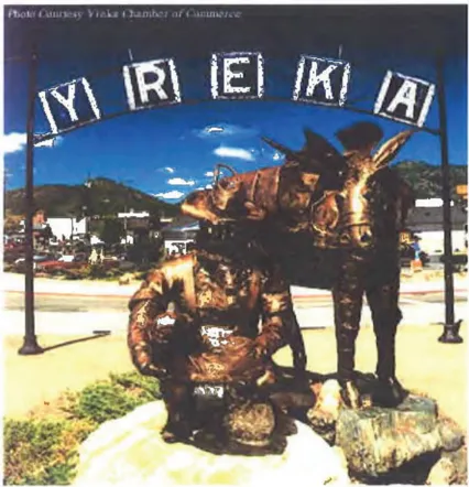 Statue of gold panner with horse underneath Yreka City Arch. Photo Courtesy of Yreka Chamber of Commerce
