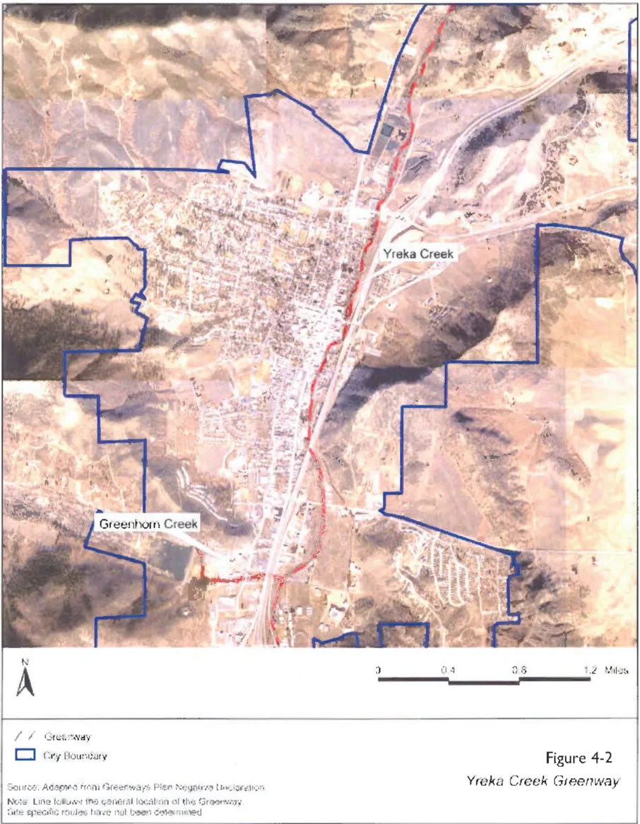 Aerial map of the City of Yreka showing the Yreka Creek Greenway route marked with a dashed red line running north-south through the city along Yreka Creek and Greenhorn Creek. The city boundary is outlined in blue. The greenway follows the general path of the creeks from the southern city limits through the urban core and northward beyond the city. Source: Adapted from the Greenways Plan Negative Declaration.